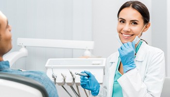 Dentist smiling at patient's dental exam