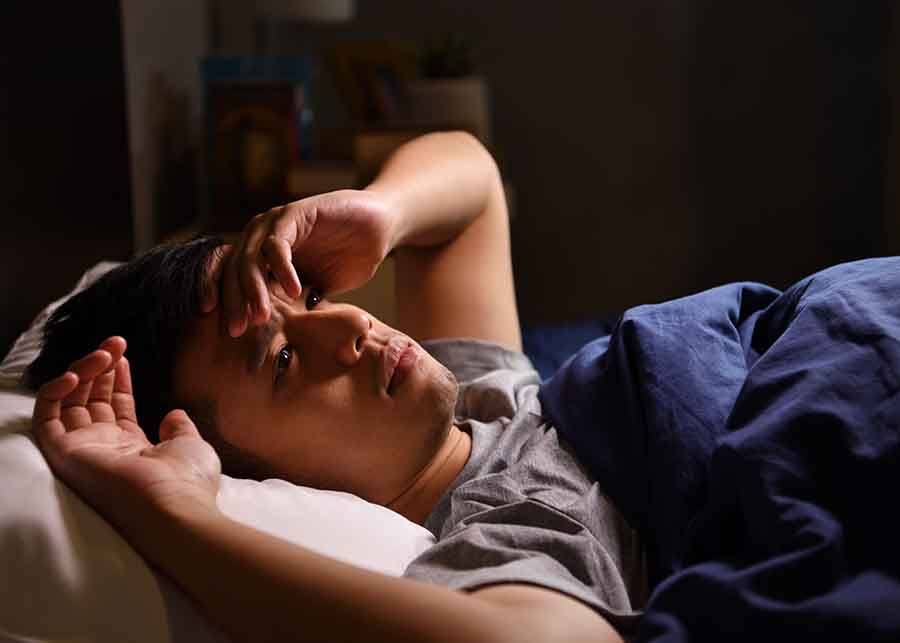 man struggling to sleep at night 