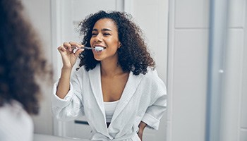 Dental implants patient in South Portland brushing