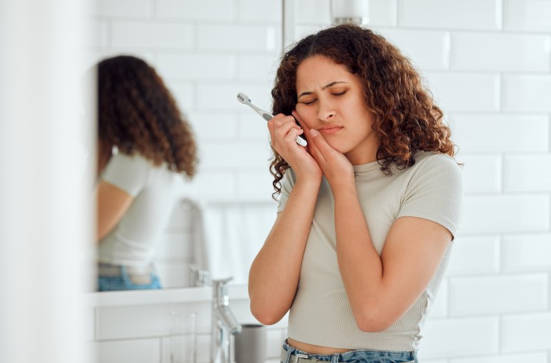 A woman suffering from tooth sensitivity